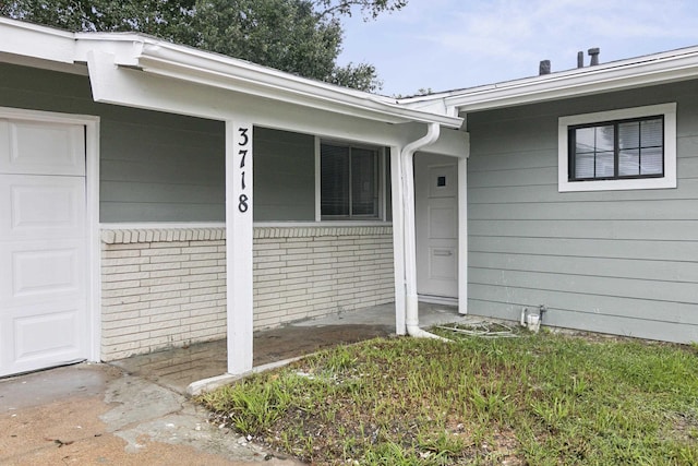 view of exterior entry featuring a garage