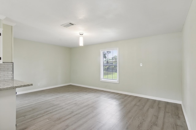 spare room featuring light hardwood / wood-style flooring