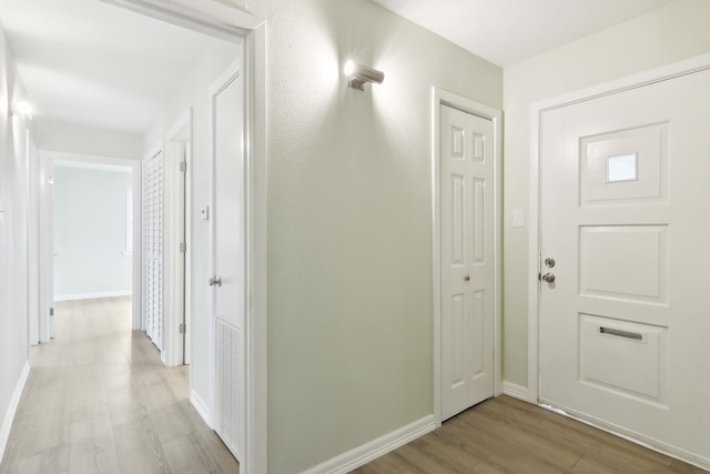 hall with light hardwood / wood-style floors