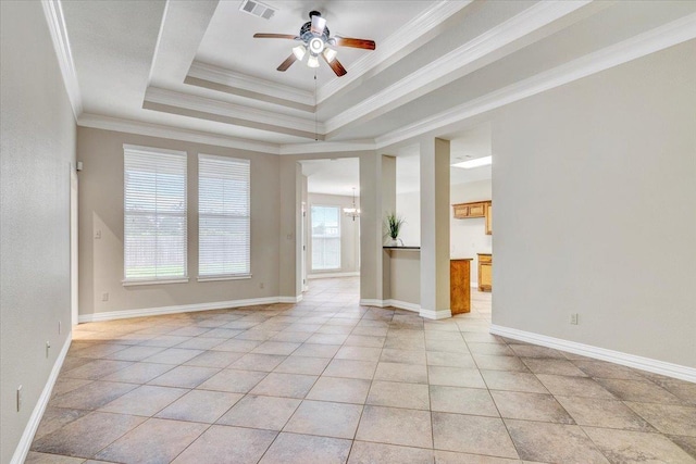 unfurnished living room with a raised ceiling, ceiling fan, ornamental molding, and light tile patterned flooring