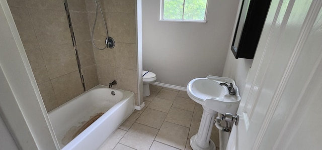 bathroom featuring tile patterned floors, tiled shower / bath combo, and toilet