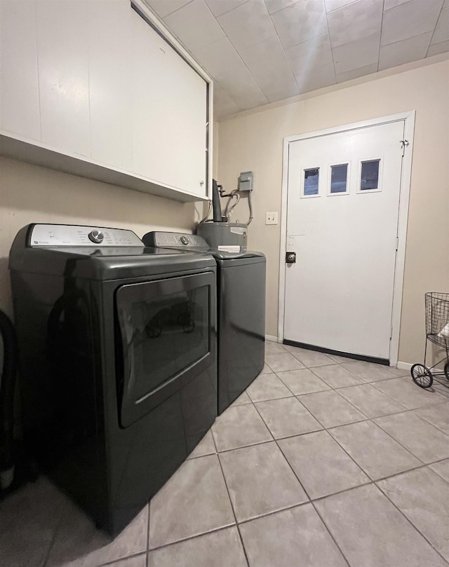 laundry room with cabinets, independent washer and dryer, and light tile patterned floors