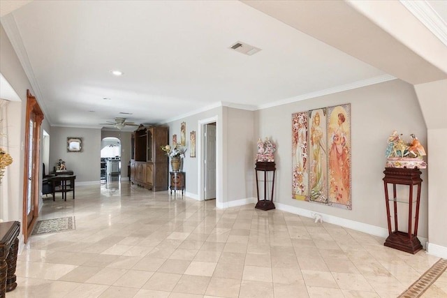 interior space with ceiling fan and crown molding