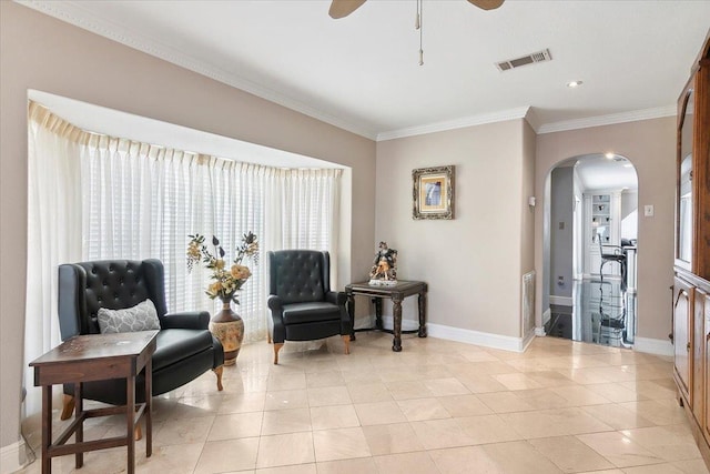 sitting room featuring ceiling fan, light tile patterned floors, and ornamental molding