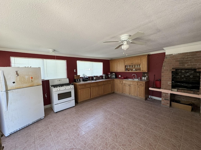 kitchen with white appliances, sink, crown molding, ceiling fan, and a textured ceiling