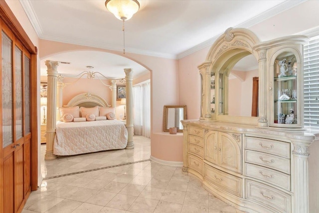 bedroom featuring ornate columns and crown molding