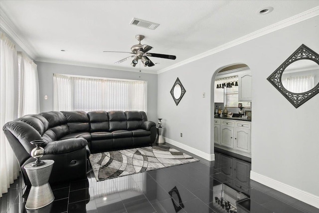 tiled living room featuring ceiling fan and crown molding