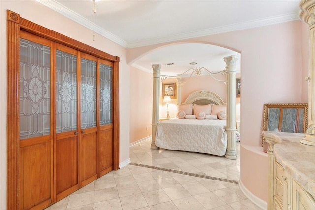 tiled bedroom with decorative columns and crown molding