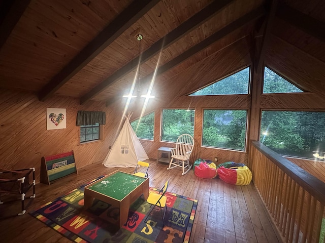 playroom with wooden walls, wood ceiling, hardwood / wood-style flooring, and lofted ceiling with beams