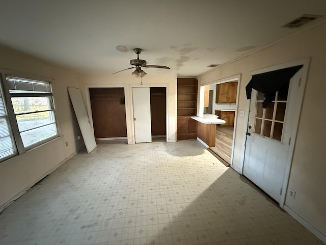 unfurnished bedroom with ensuite bath and ceiling fan