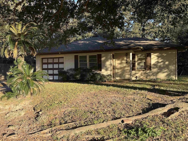 view of front of house with a front yard and a garage