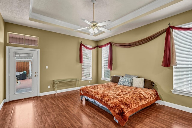 bedroom with ceiling fan, a textured ceiling, and hardwood / wood-style flooring