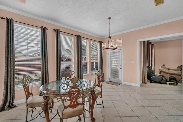 tiled dining space with ornamental molding, a textured ceiling, and a chandelier