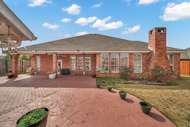 rear view of house with a yard and a patio