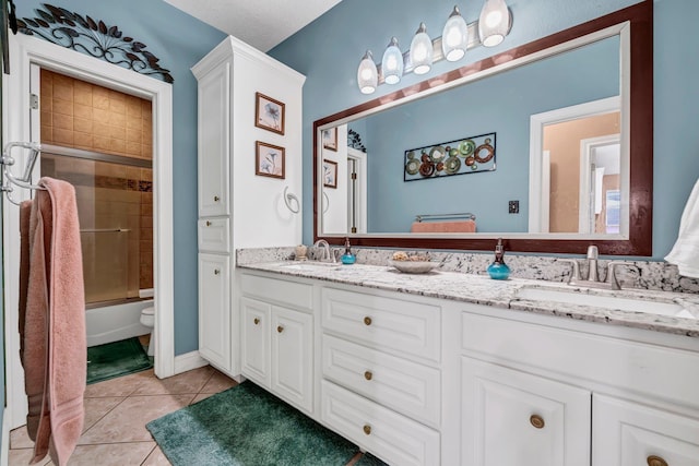 full bathroom featuring tile patterned flooring, vanity, toilet, and enclosed tub / shower combo