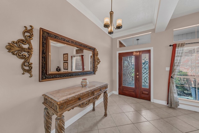 tiled foyer entrance featuring a notable chandelier, ornamental molding, and french doors