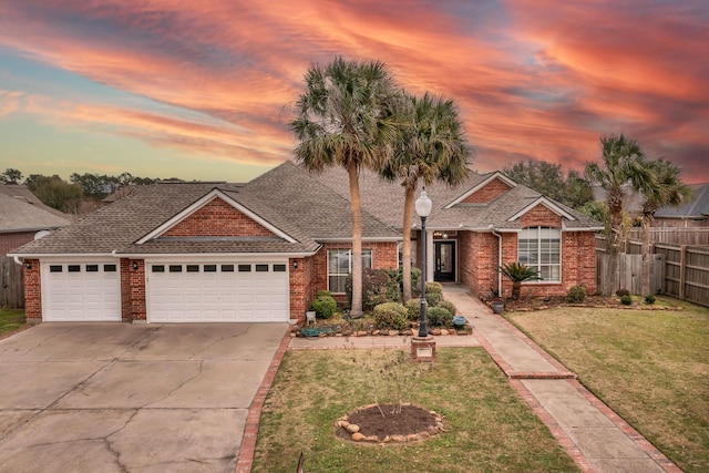 view of front of house featuring a yard and a garage