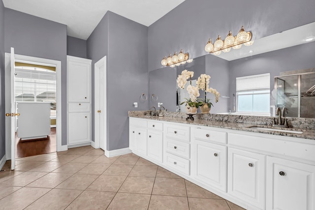 bathroom with tile patterned floors, vanity, and an enclosed shower