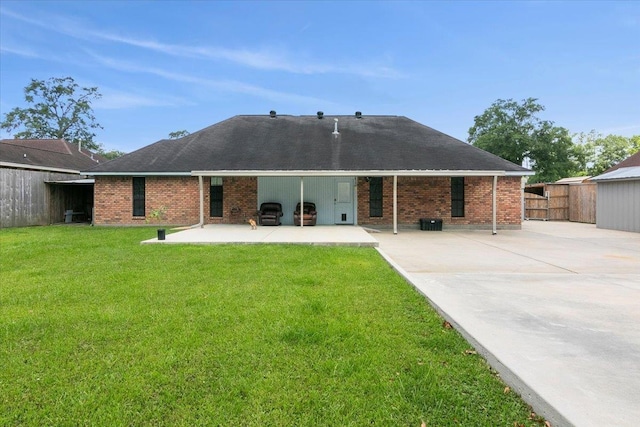 back of property featuring a lawn, cooling unit, and a patio