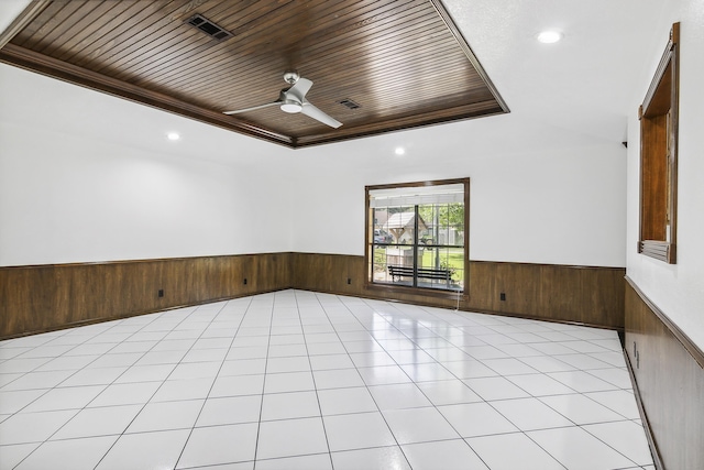 spare room with ceiling fan, wood ceiling, and crown molding