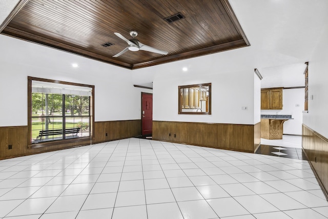 unfurnished room featuring ceiling fan, light tile patterned flooring, wood ceiling, and crown molding