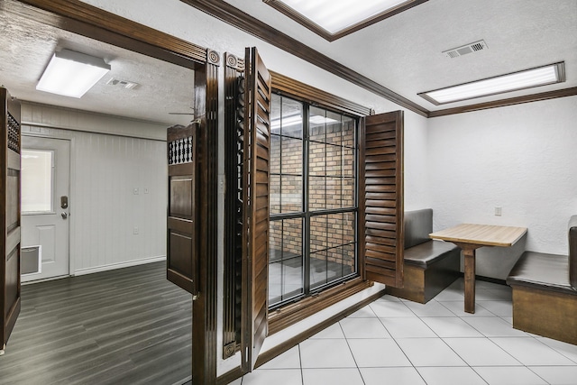 wine room featuring crown molding and a textured ceiling