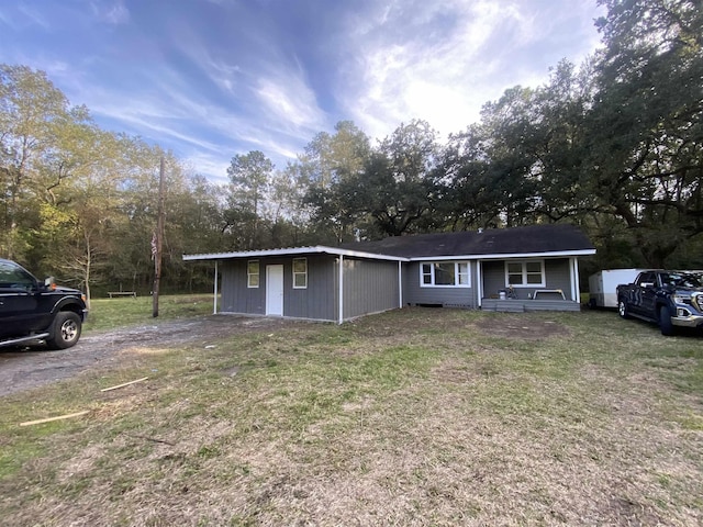 ranch-style house with a front lawn and a porch