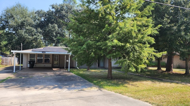 obstructed view of property with a front yard and solar panels