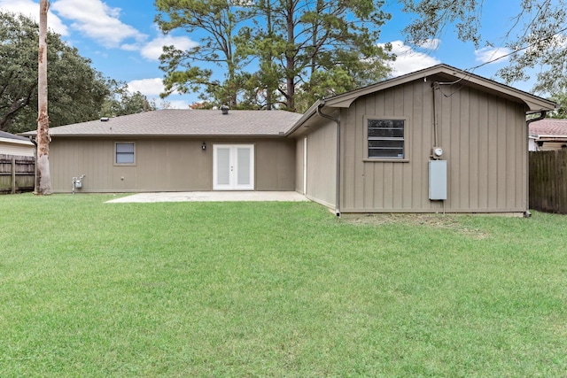 back of property with french doors, a yard, and a patio area