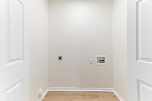 clothes washing area with hookup for an electric dryer, washer hookup, and hardwood / wood-style flooring