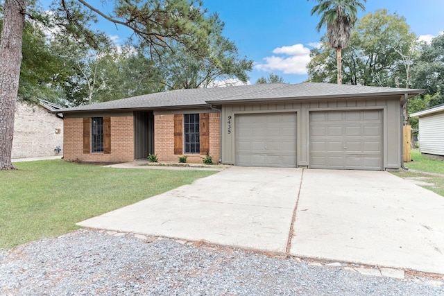 single story home with a garage and a front lawn