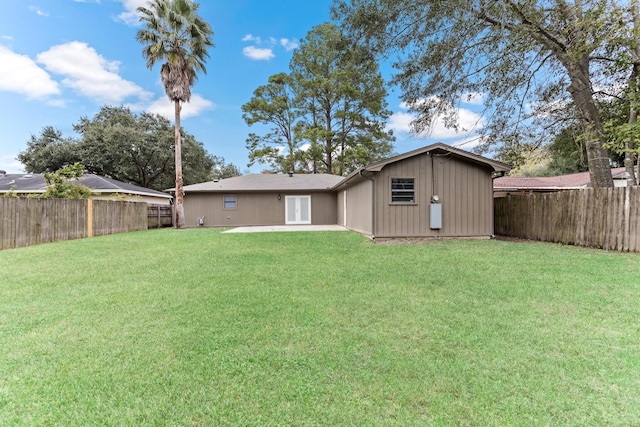 rear view of house featuring a patio and a lawn