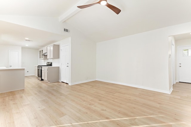 unfurnished living room featuring ceiling fan, lofted ceiling with beams, and light wood-type flooring