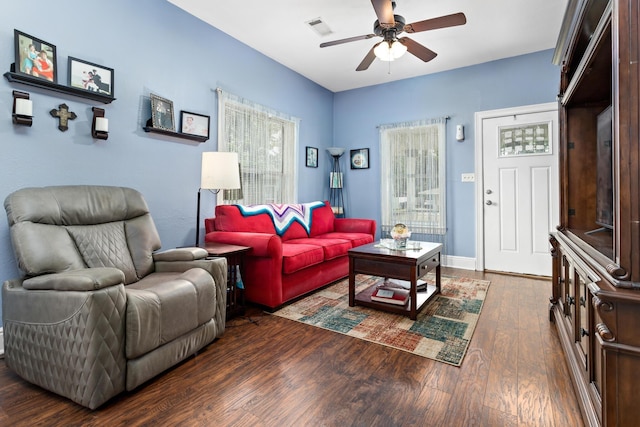 living room with ceiling fan and dark hardwood / wood-style flooring