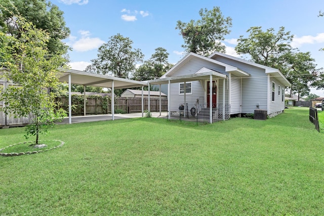 exterior space with a lawn and central AC