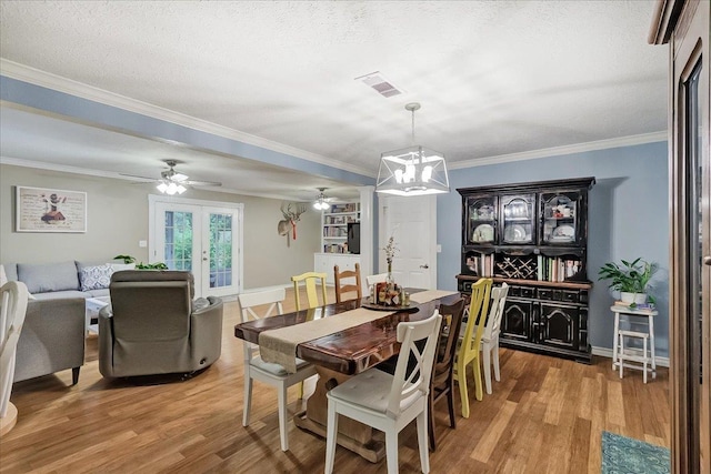 3821 Suncrest Dr, Groves, TX 77619 - dining area featuring a ceiling fan, light wood-style floors, a chandelier, french doors, and ornamental molding