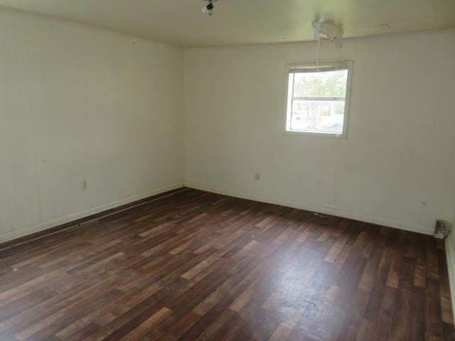 spare room featuring dark hardwood / wood-style flooring