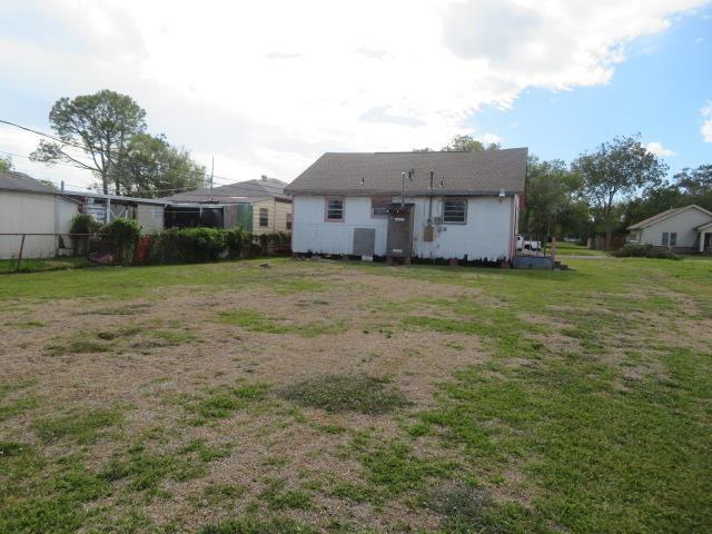 rear view of house with a yard