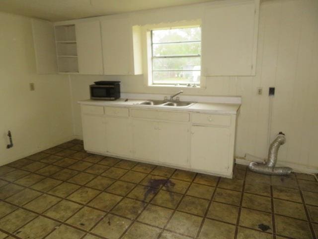 kitchen with white cabinetry and sink