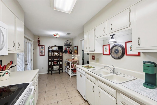 1006 Park Meadow Dr, Beaumont, TX 77706 - kitchen featuring white appliances, light countertops, light tile patterned flooring, and white cabinetry