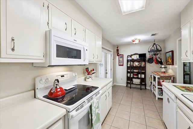 1006 Park Meadow Dr, Beaumont, TX 77706 - kitchen with white appliances, light countertops, white cabinets, and light tile patterned flooring