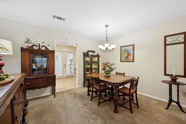 1006 Park Meadow Dr, Beaumont, TX 77706 - dining room with light carpet, a chandelier, and french doors