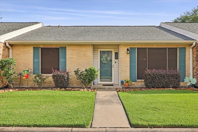 1006 Park Meadow Dr, Beaumont, TX 77706 - ranch-style house with roof with shingles, a front lawn, and brick siding