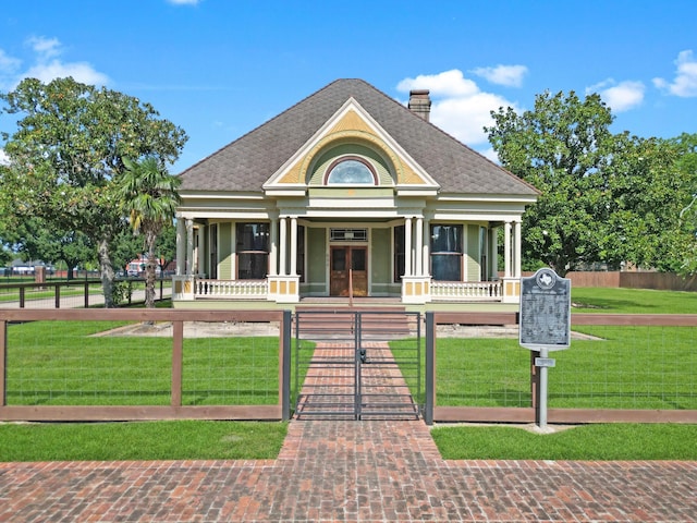 view of front of property with a front yard and a porch