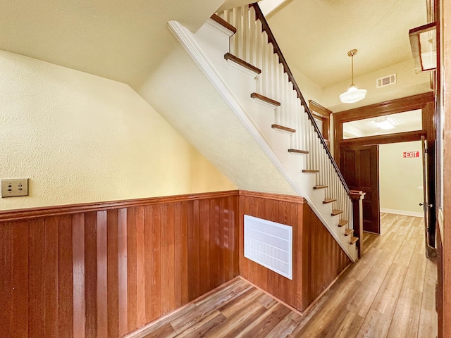 staircase with hardwood / wood-style flooring