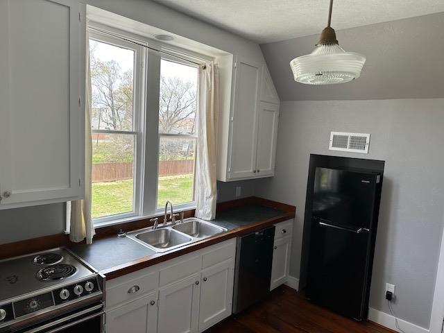 kitchen featuring white cabinetry, sink, and black appliances