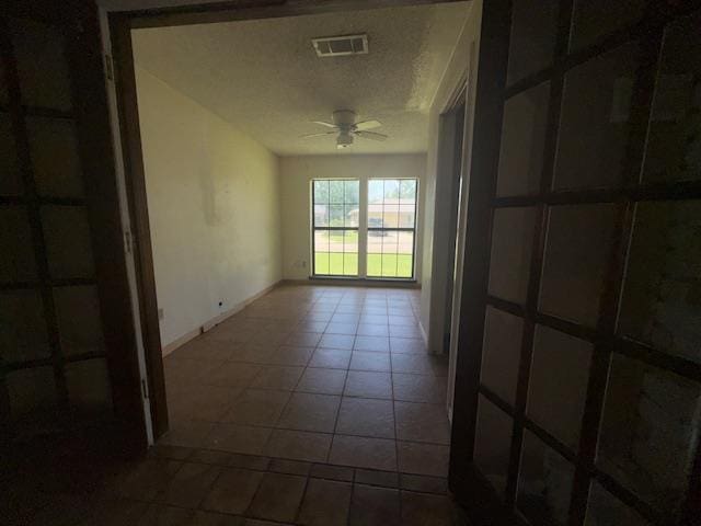 290 Rosine St, Beaumont, TX 77707 - tiled spare room featuring ceiling fan and baseboards