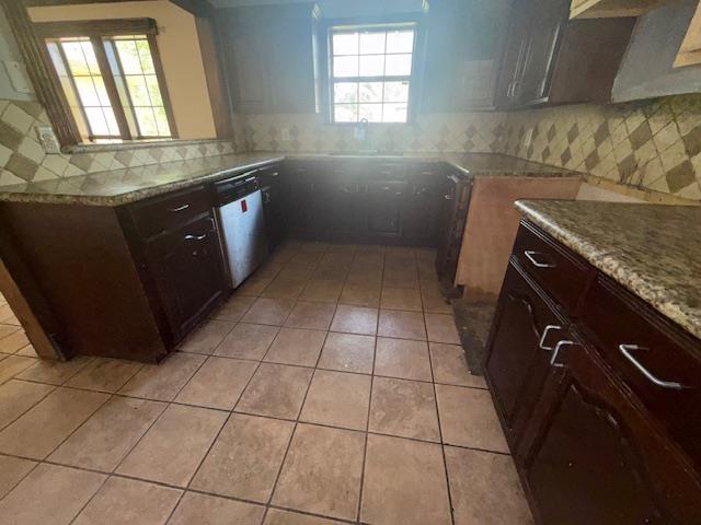 290 Rosine St, Beaumont, TX 77707 - kitchen featuring dishwasher, light tile patterned floors, tasteful backsplash, and dark brown cabinets