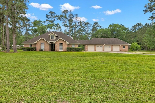 view of front of home with a front yard and a garage