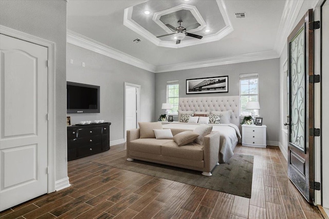 bedroom with a tray ceiling, ceiling fan, and ornamental molding